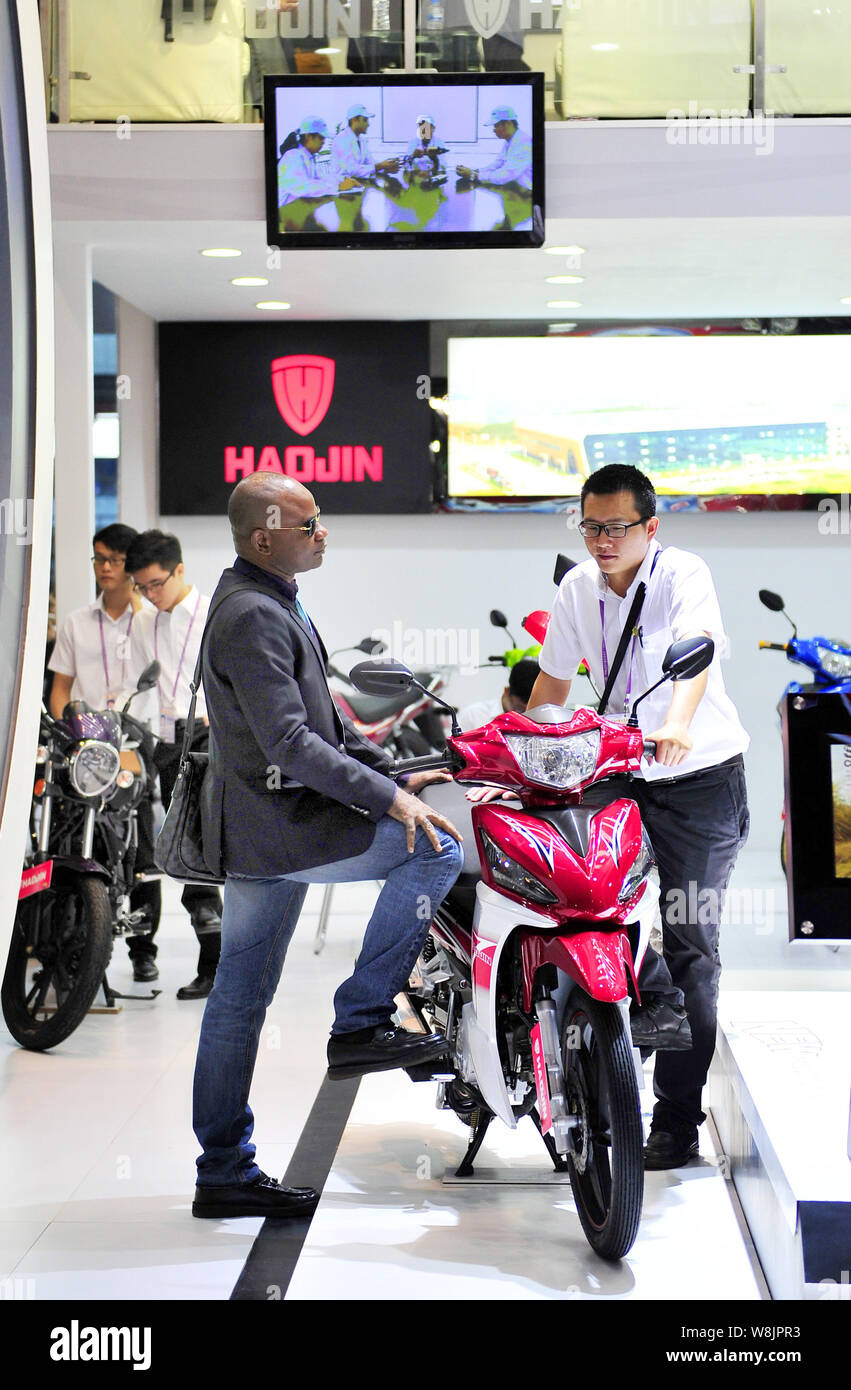 A foreign buyer, left, talks with a motorbike exhibitor at the stand of  Guangzhou Haojin Motorcycle Group Co., Ltd. during the 118th China Import  and Stock Photo - Alamy