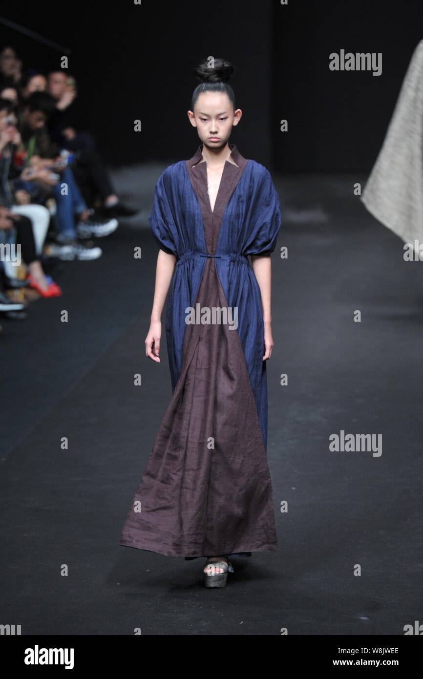 A model displays a new creation by fashion designer Li Shiyong at a ...