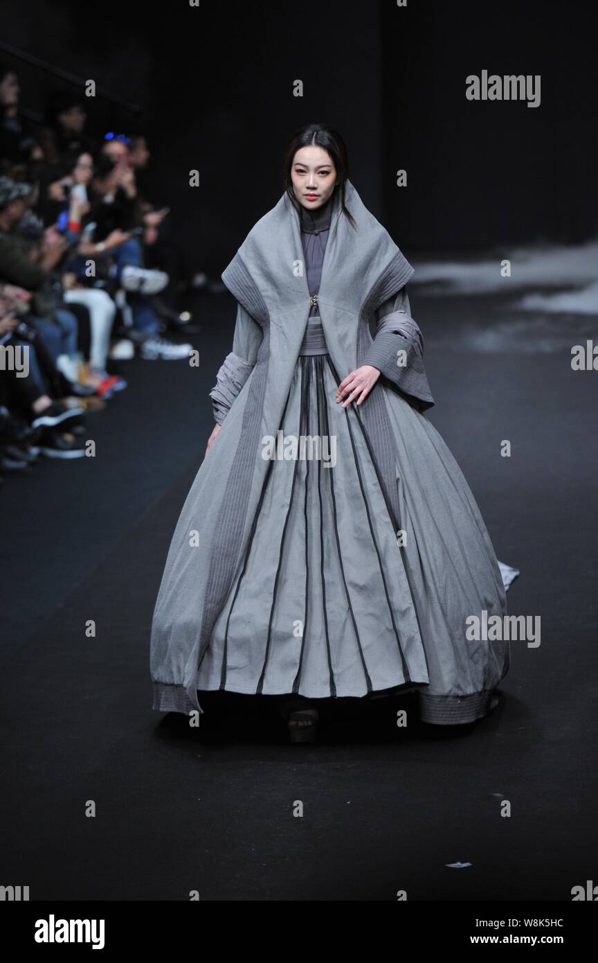 A model displays a new creation by fashion designer Li Shiyong at a ...
