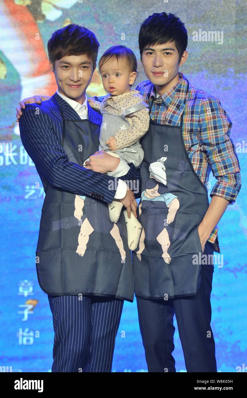 Chinese actors Zhang Yixing, left, and Chen Xuedong pose with a little baby at a press