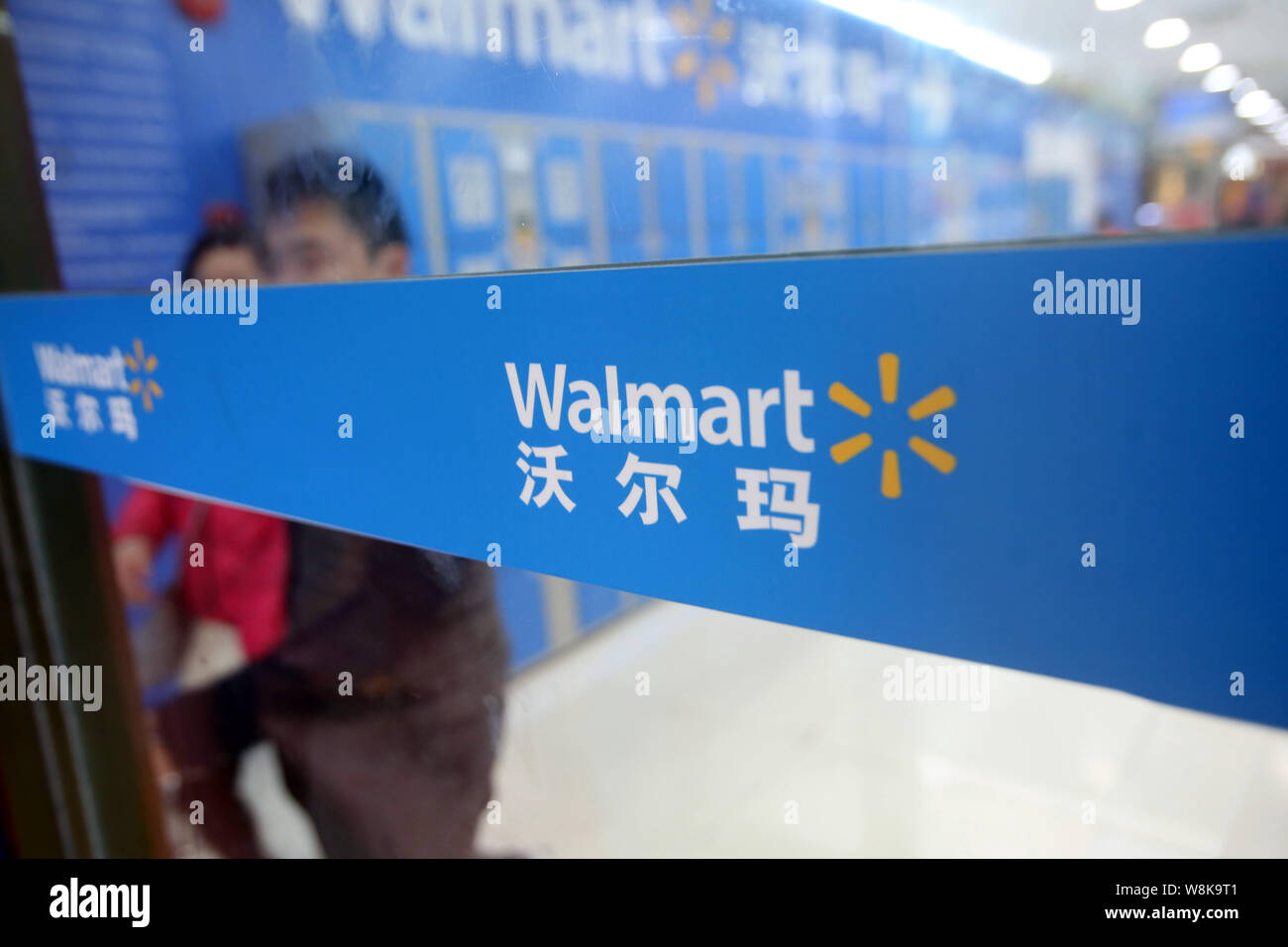 FILECustomers exit from a supermarket of Walmart in Shanghai, China