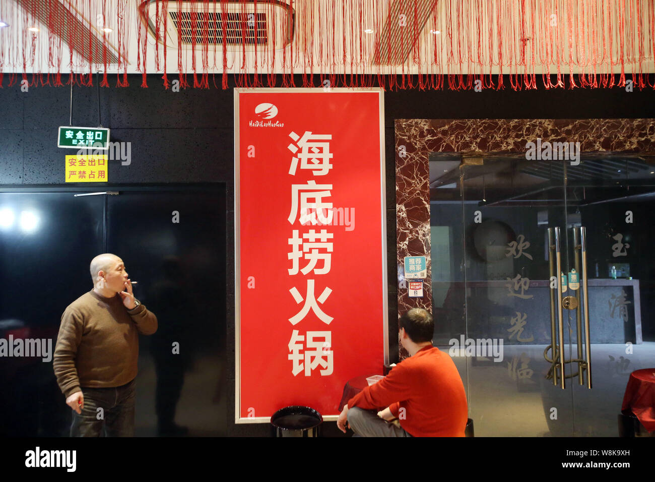 FILECustomers wait outside a hotpot restaurant of Haidilao in