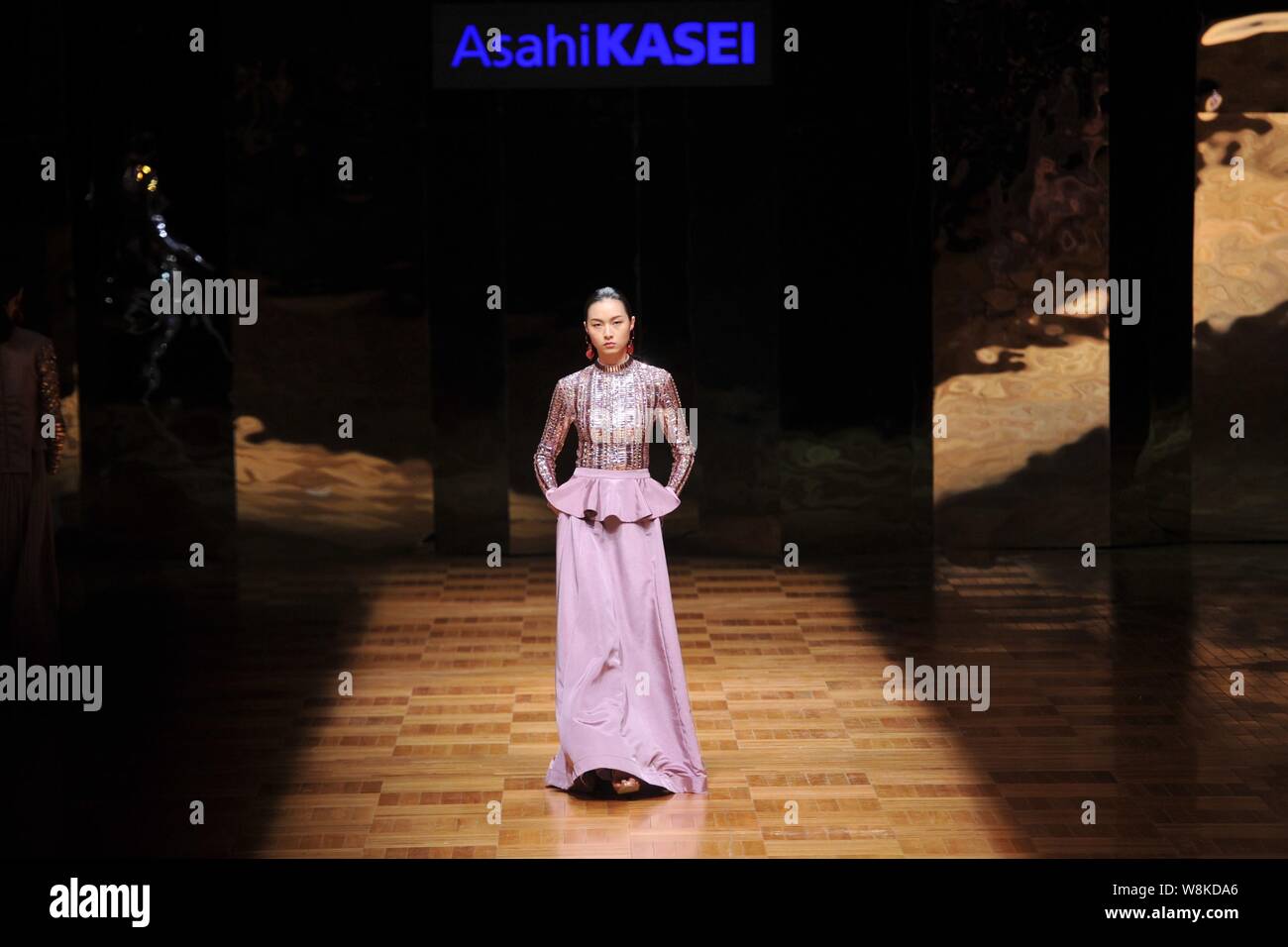 A model displays a new creation at the Asahi Kasei Chinese Fashion ...