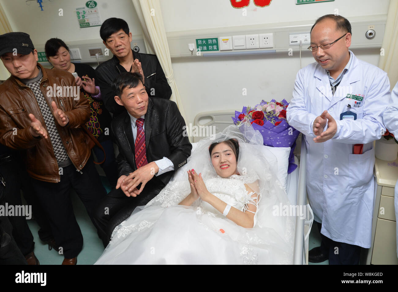 Terminally ill Chinese woman Yang Liu dressed in a wedding gown, second right, and her husband Peng Xin, second left, are pictured during their weddin Stock Photo