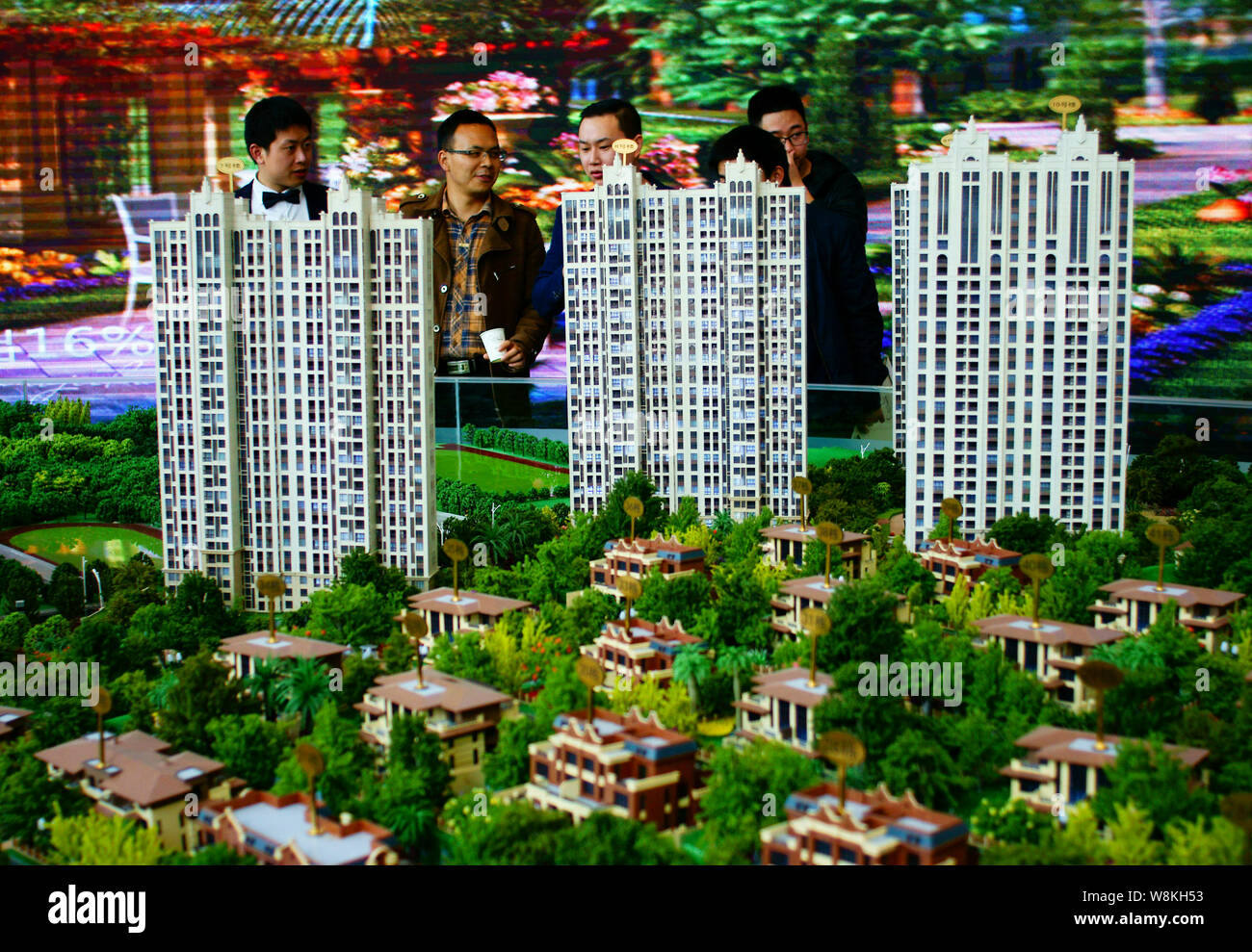 Chinese homebuyers look at housing models at the sales center of a