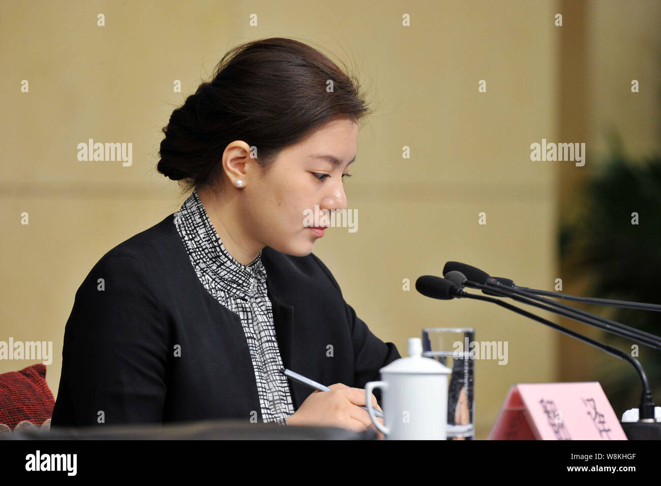 Female Chinese translator Zhang Jing interprets at a press conference