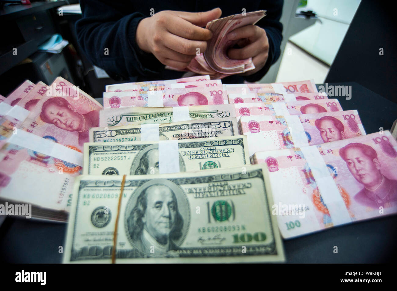 Counting Rmb --FILE--A Chinese clerk counts RMB (renminbi) yuan and US dollar ...