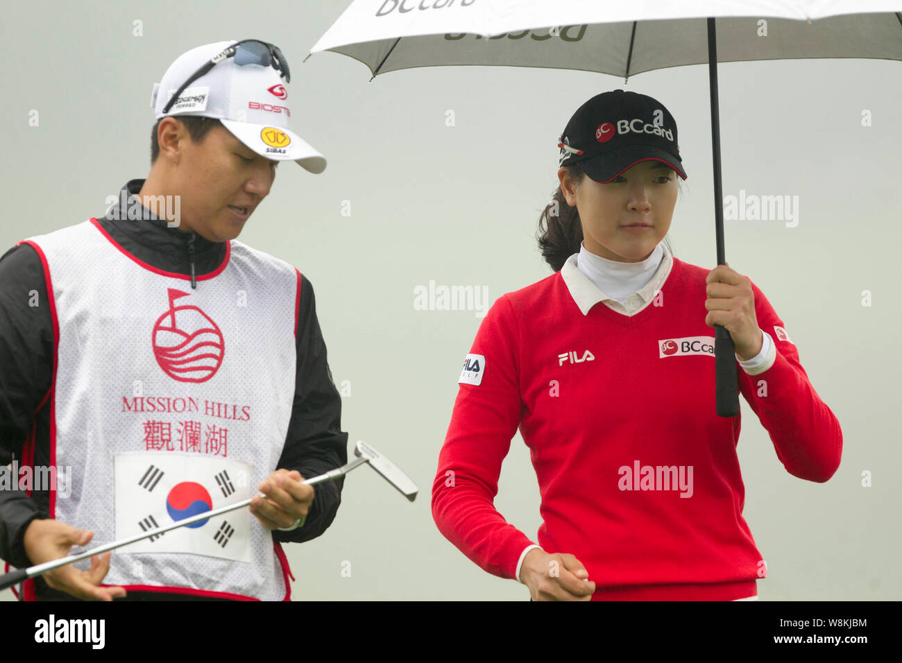 South Korea's Lee Jung-min, right, listens to her caddie during the World  Ladies Championship at Mission Hills Golf Club in Shenzhen city, south China  Stock Photo - Alamy