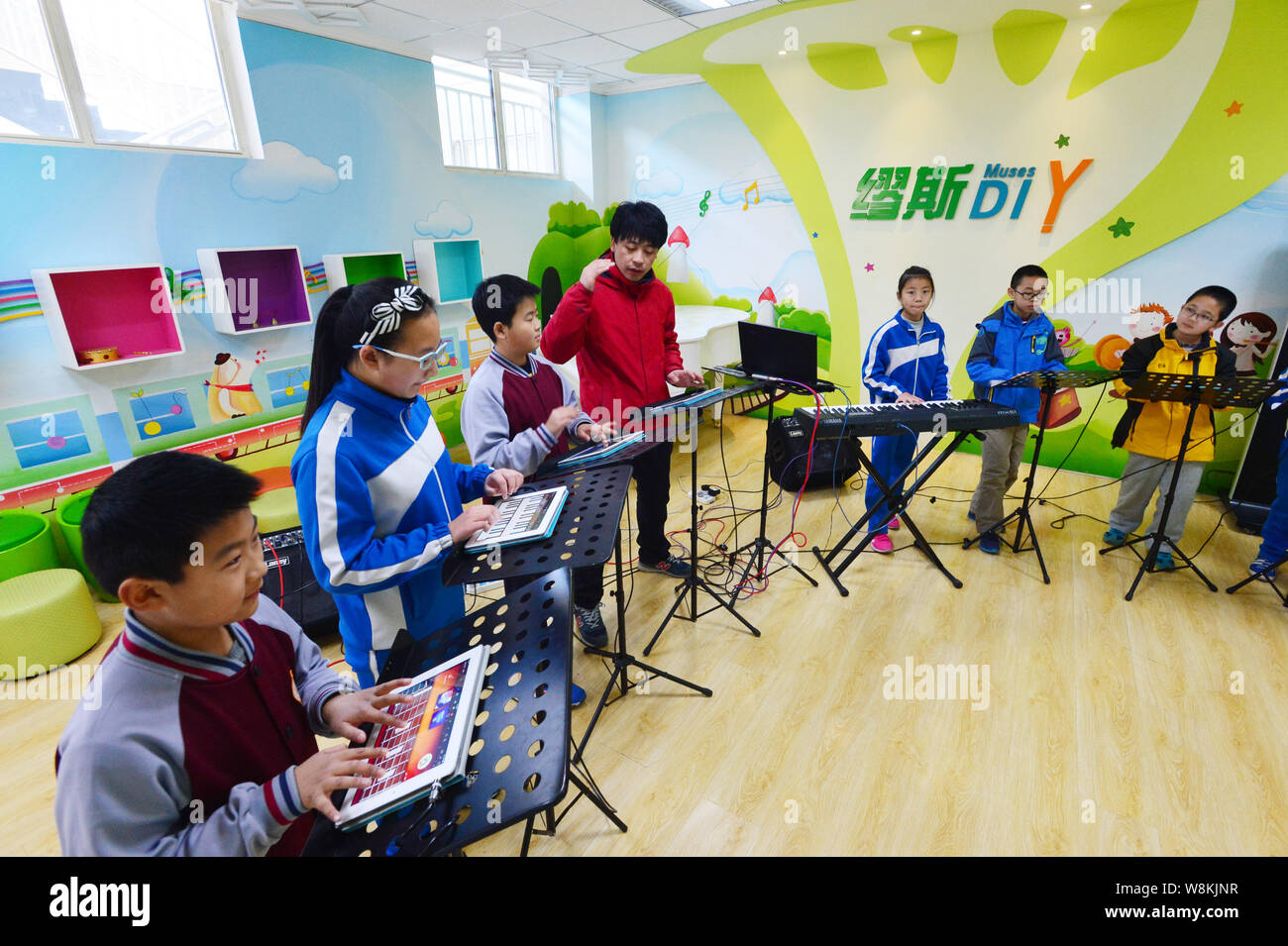 A Chinese teacher instruct the pupils of the "iPad Band" to play