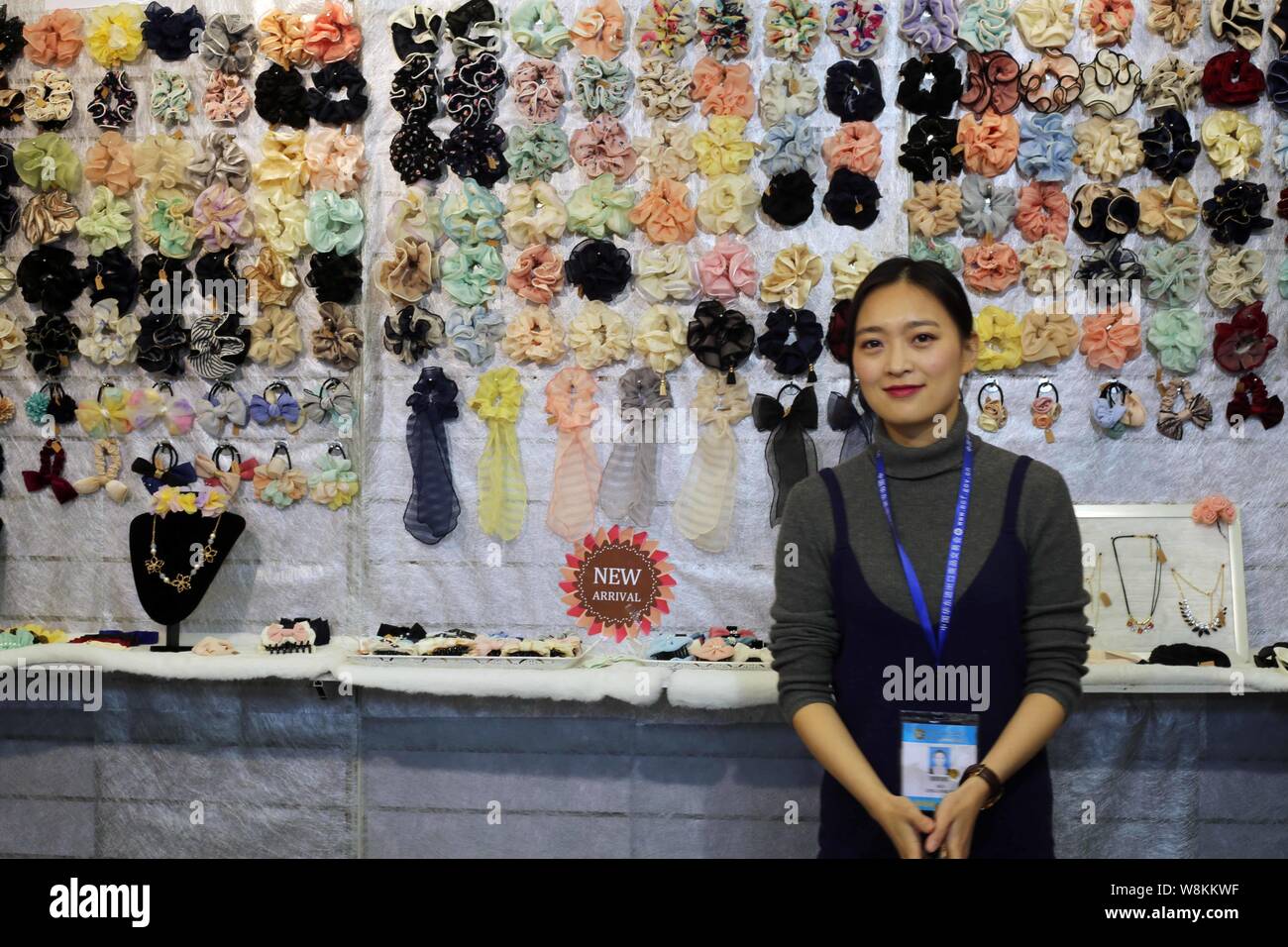 An exhibitor poses in front of hair accessories on display during the 26th  East China Import & Export Commodity Fair, also known as East China Fair (E  Stock Photo - Alamy