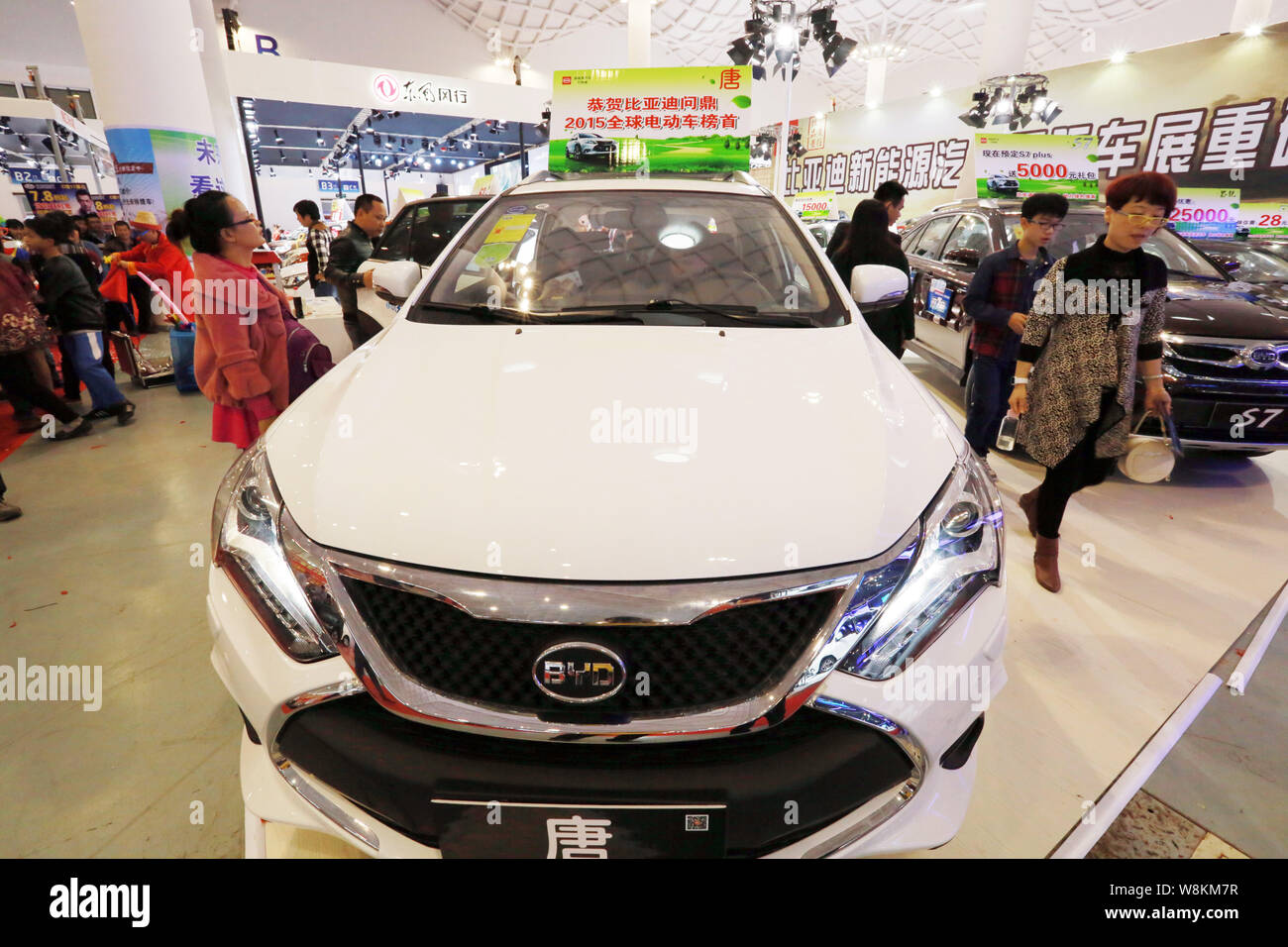 --FILE--Visitors look at BYD hybrid cars on display during an auto show in Haikou city, south China's Hainan province, 12 March 2016.  BYD Co., the Wa Stock Photo