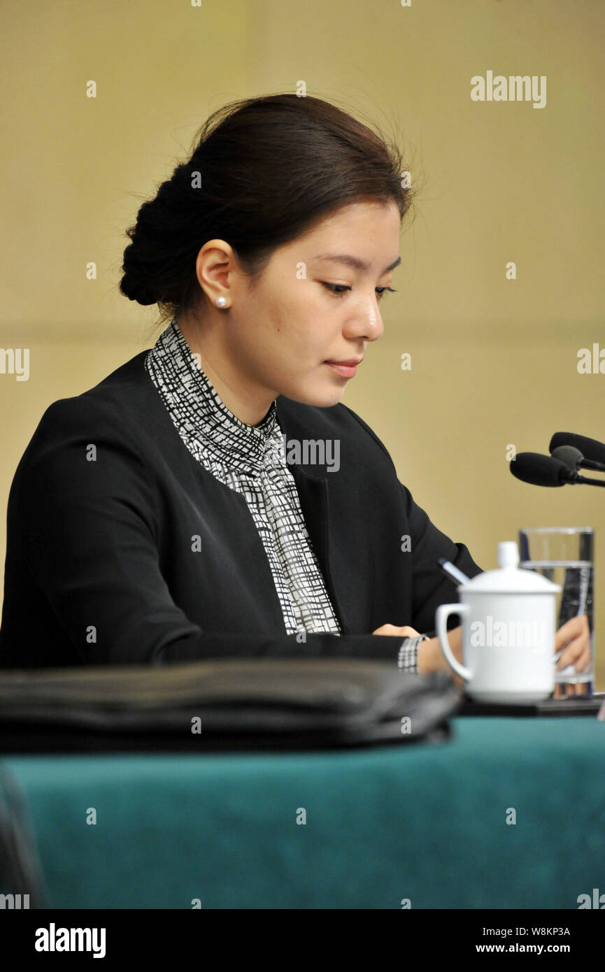 Female Chinese translator Zhang Jing interprets at a press conference
