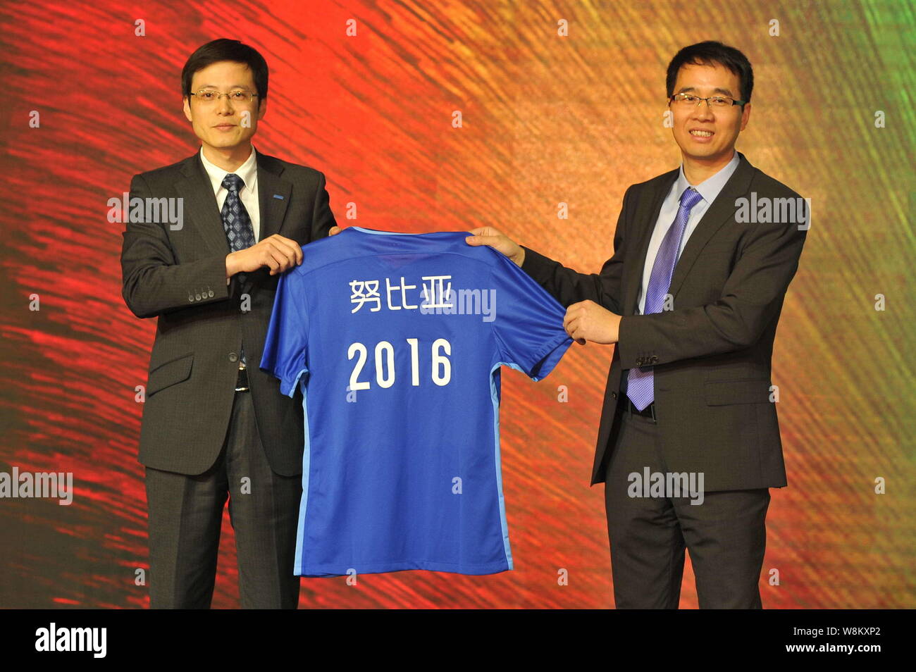 Ni Fei, right, CEO of ZTE's Nubia smartphone unit, and Liu Jun, president of Jiangsu Suning Football Club pose with a soccer shirt during the signing Stock Photo