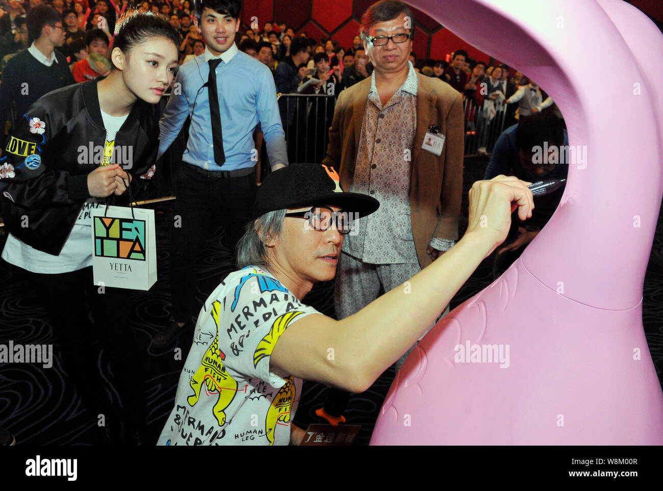 Hong Kong director Stephen Chow signs an autograph during a promotional  event for his movie The Mermaid in Fuzhou city, southeast China's Fujian  pro Stock Photo - Alamy