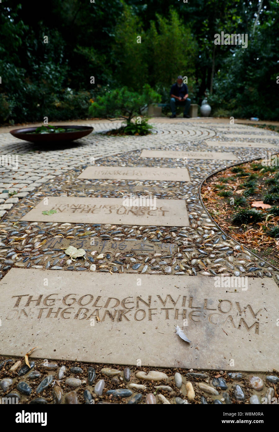 Cambridge, UK. 9th Aug, 2019. The poem of 'Second Farewell to Cambridge' by Chinese poet Xu Zhimo engraved on the path in both Chinese and English is seen at the Xu Zhimo Garden in King's College during the 5th Cambridge Xu Zhimo Poetry and Art Festival 2019 in Cambridge, Britain on Aug. 9, 2019. TO GO WITH 'Feature: Xu Zhimo memorial garden opens at King's College Cambridge' Credit: Han Yan/Xinhua/Alamy Live News Stock Photo