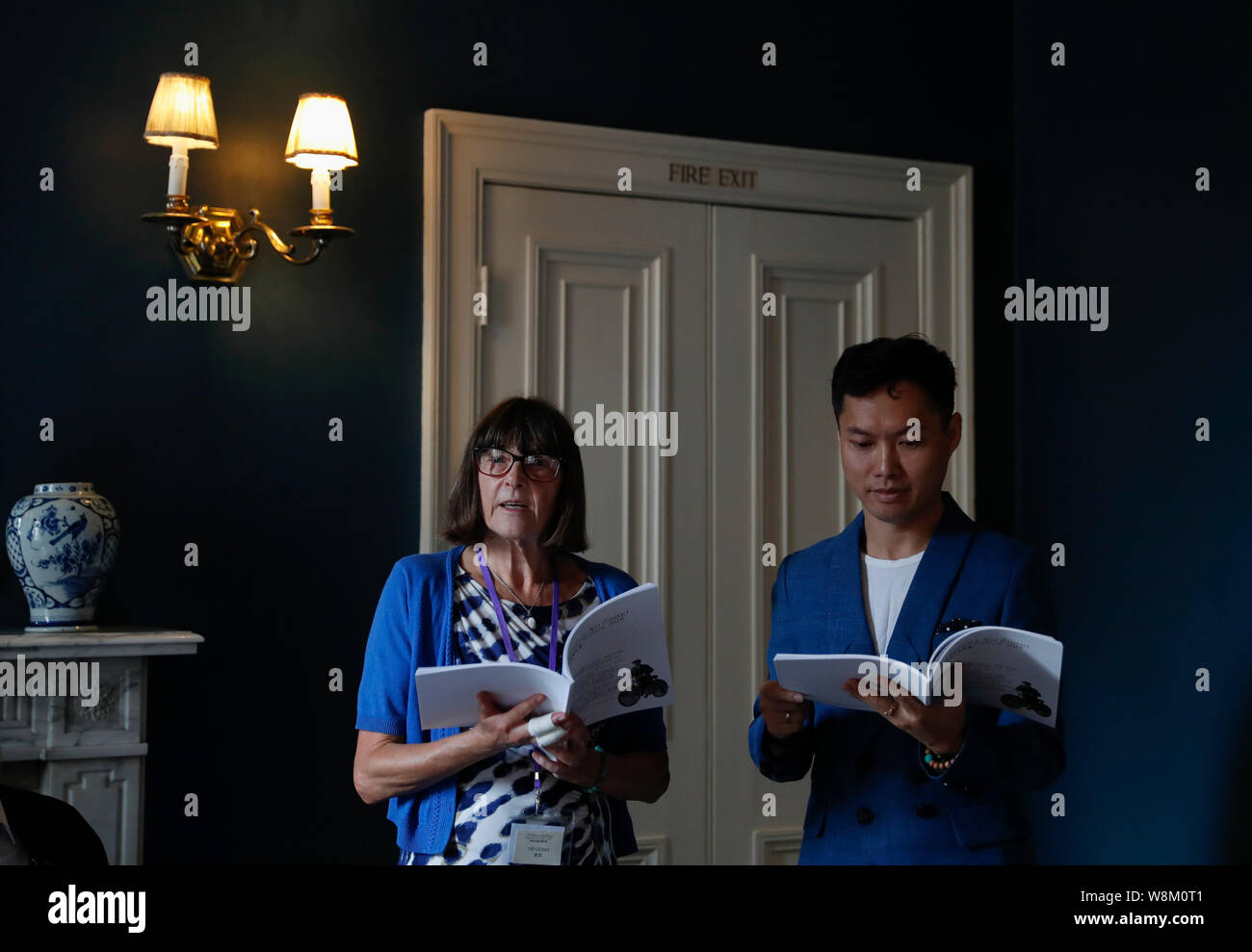 Cambridge, UK. 9th Aug, 2019. A poet (L) reads her poem with a Chinese professional reader during the 5th Cambridge Xu Zhimo Poetry and Art Festival 2019 at King's College, University of Cambridge, in Cambridge, Britain on Aug. 9, 2019. TO GO WITH 'Feature: Xu Zhimo memorial garden opens at King's College Cambridge' Credit: Han Yan/Xinhua/Alamy Live News Stock Photo