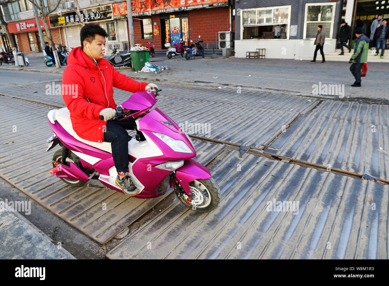 Steel Plate Riding A cyclist rides on steel plates with rebar on a road in Zhengzhou city ...