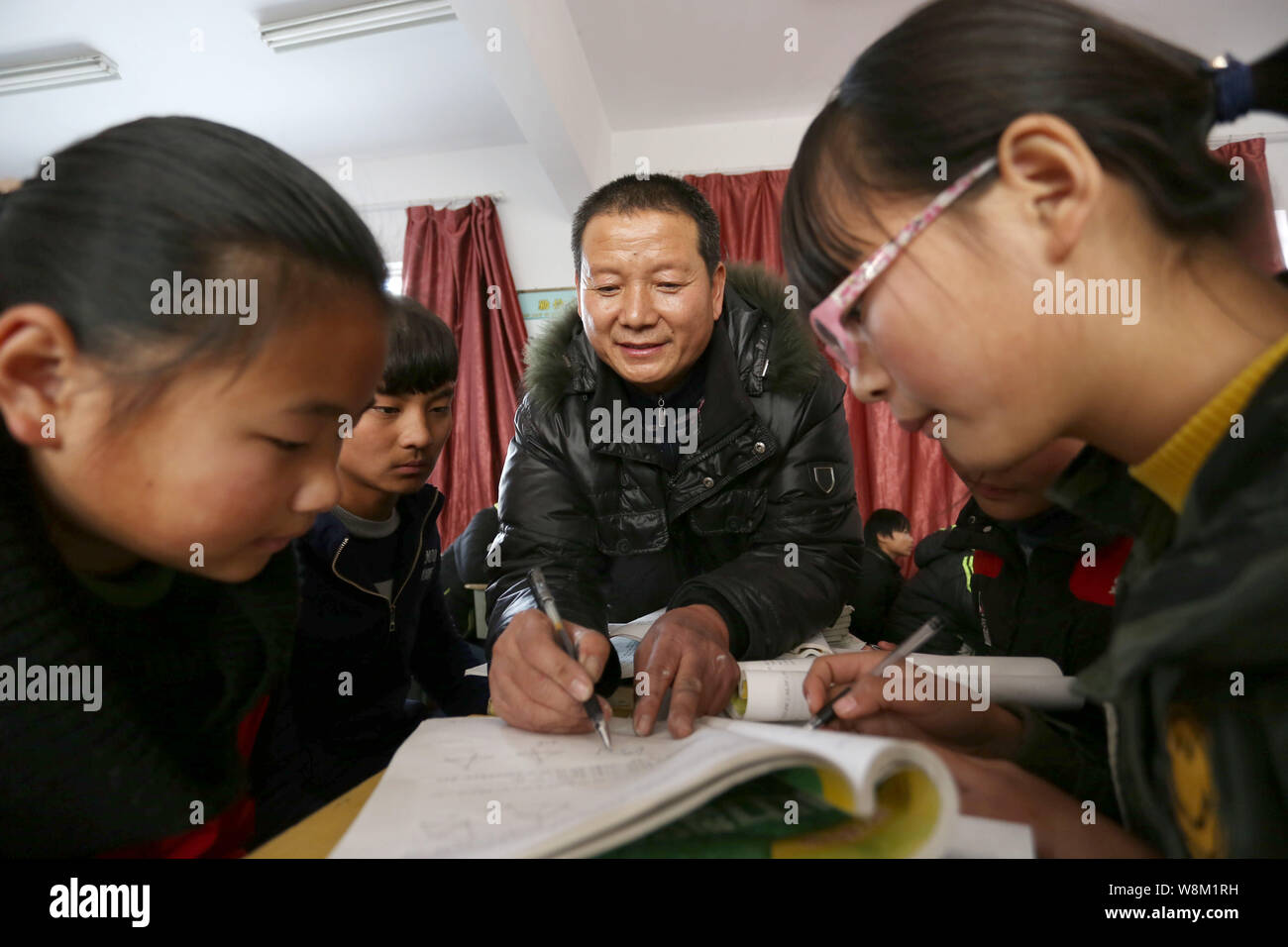 --FILE--A male Chinese teacher instructs his students in a classroom at ...