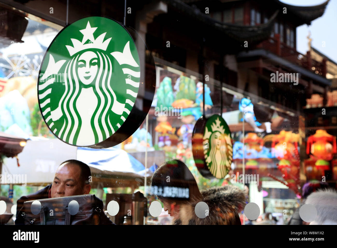 FILE--Chinese customers enjoy coffee in the cafe of Starbucks