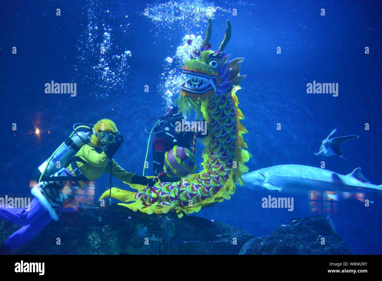 Chinese divers dressed in the diving suits of "Monkey King" and dragon