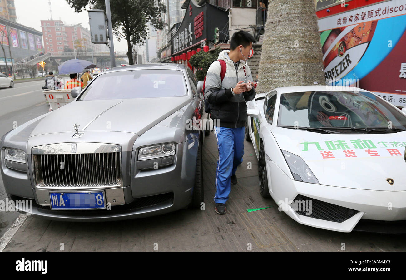 A Chinese Student Walks Past A Lamborghini Gallardo Sports Car And A Rolls Royce Limousine Parked In Front Of The Newly Opened Jiuweihe Bun Shop In Ch Stock Photo Alamy