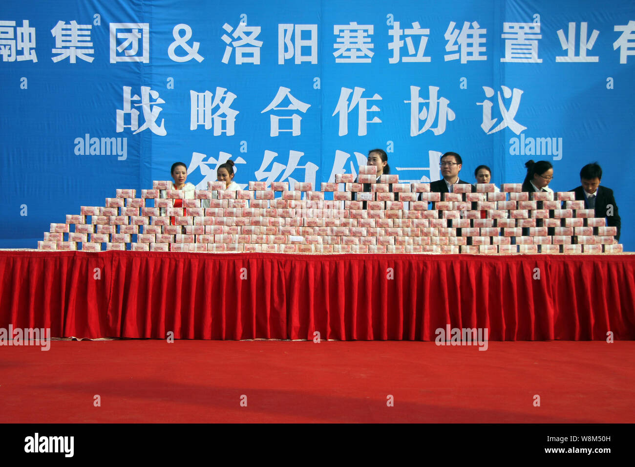 Chinese employees prepare stacks of 100-yuan RMB (Renminbi) banknotes ...