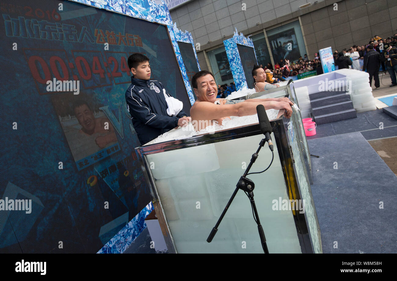 Chen Kecai, left, and Xiang Yong, two "ice men" known for their abilities to withstand extreme coldness, immerse themselves in boxes filled with ice d Stock Photo