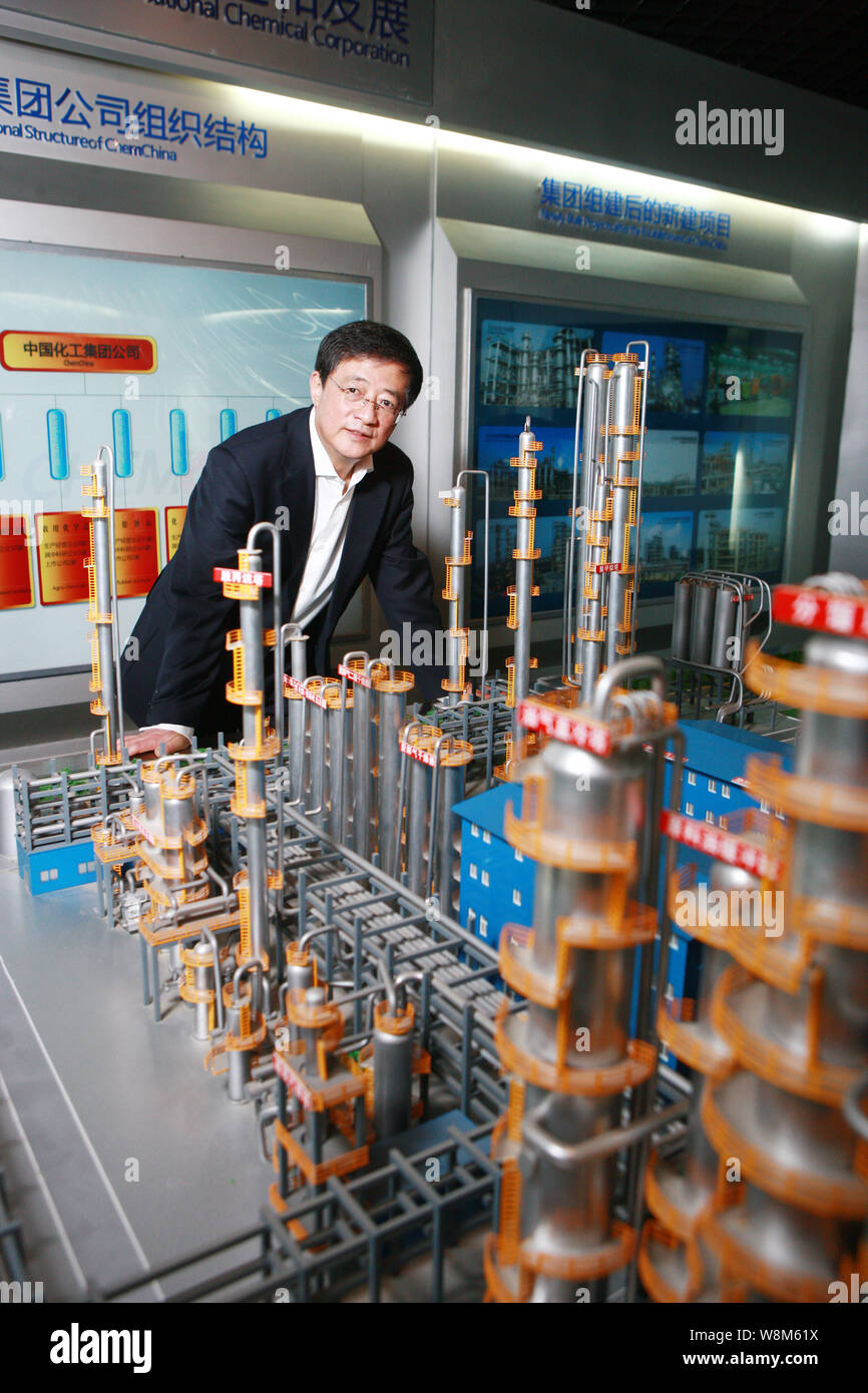 --FILE--Ren Jianxin, Chairman of ChemChina (China National Chemical Corporation), poses next to a model of a chemical plant at the headquarters of Che Stock Photo
