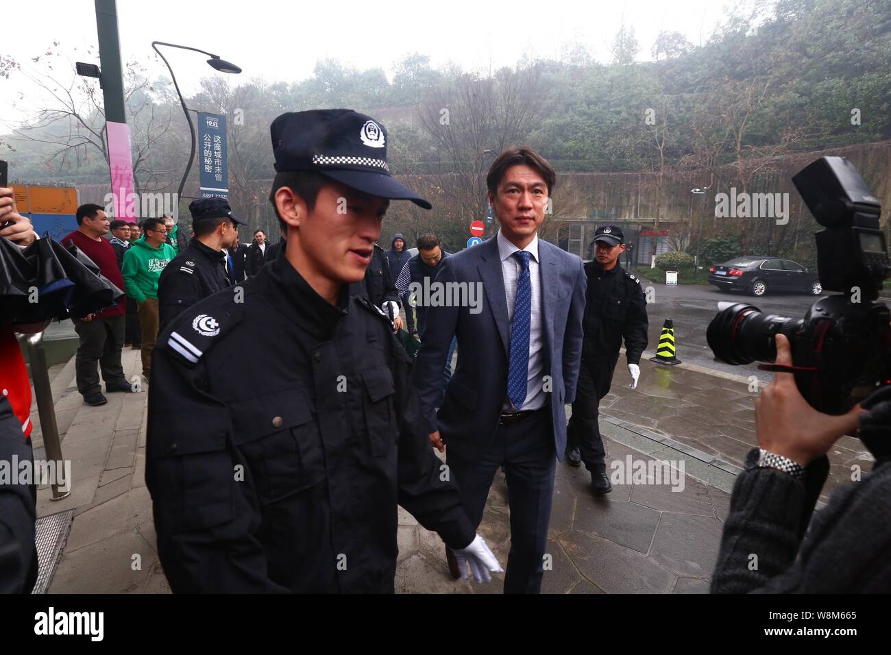 South Korean football coach and manager Hong Myungbo, front right, arrives for a press