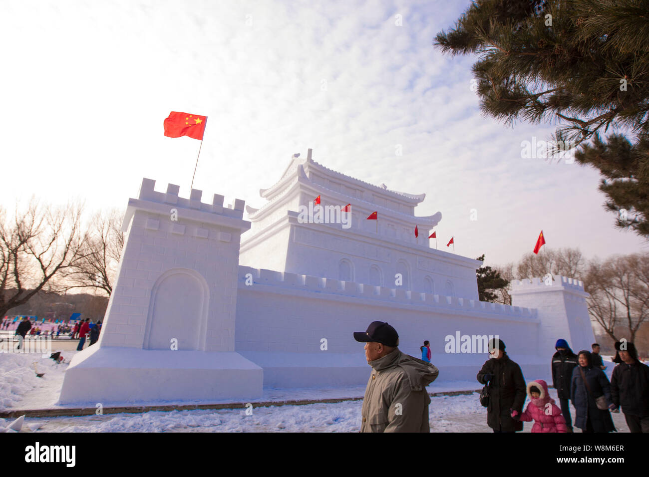 Tourists look at a snow sculpture resembling Beijing's Tiananmen Rostrum in a park in Changchun city, northeast China's Jilin Province, 3 January 2016 Stock Photo