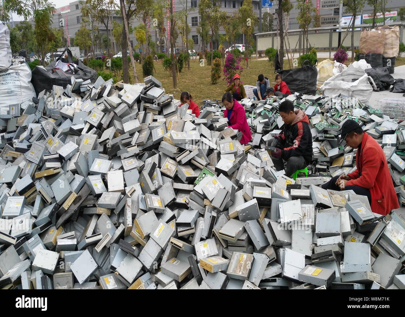 Chinese workers remove components from hard drives of computers at a factory in Guiyu town, Shantou city, south China's Guangdong province, 26 Decembe Stock Photo