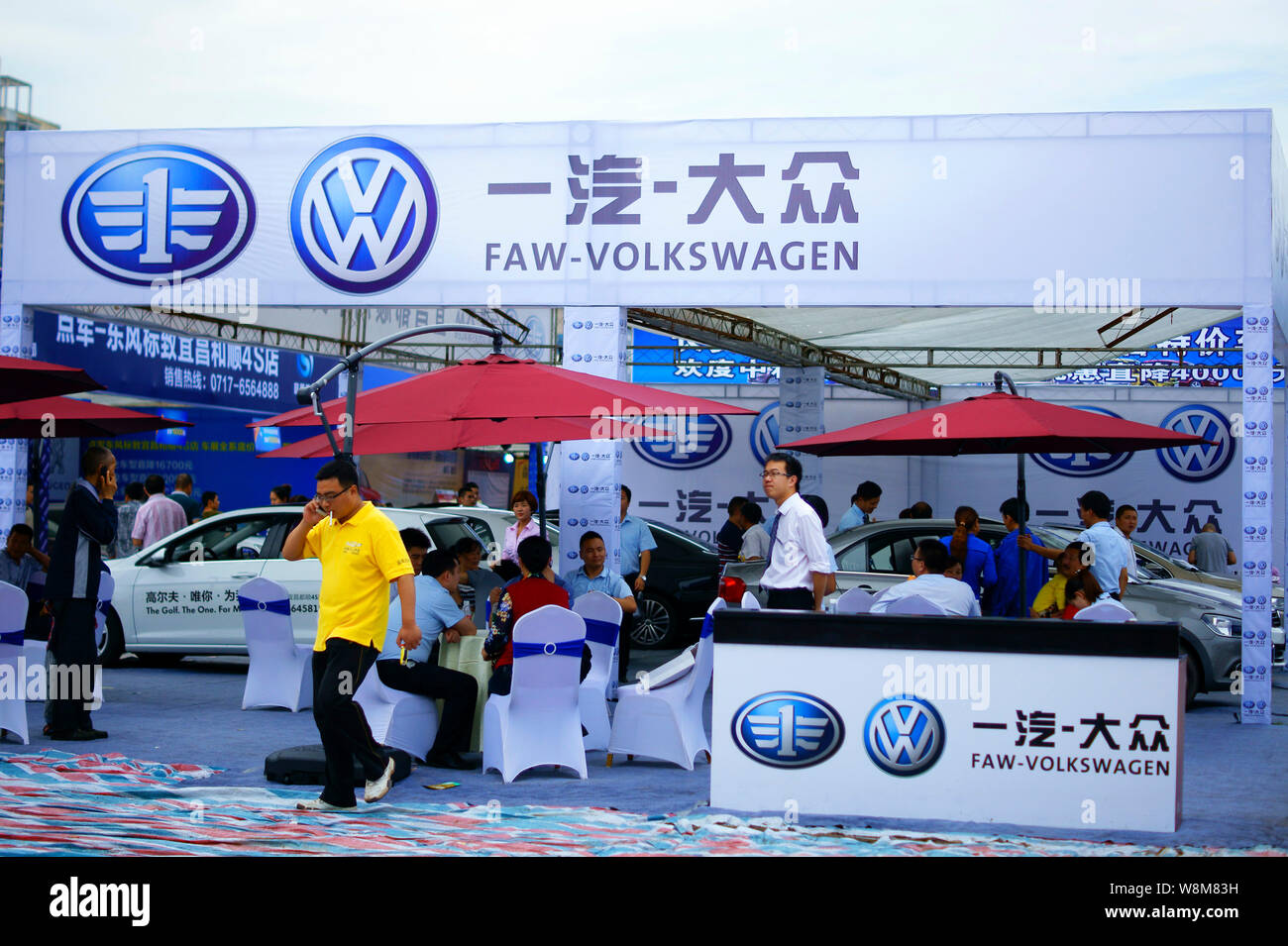 --FILE--People visit the stand of FAW-Volkswagen, a joint venture between FAW and VW, during an automobile exhibition in Yichang city, central China's Stock Photo