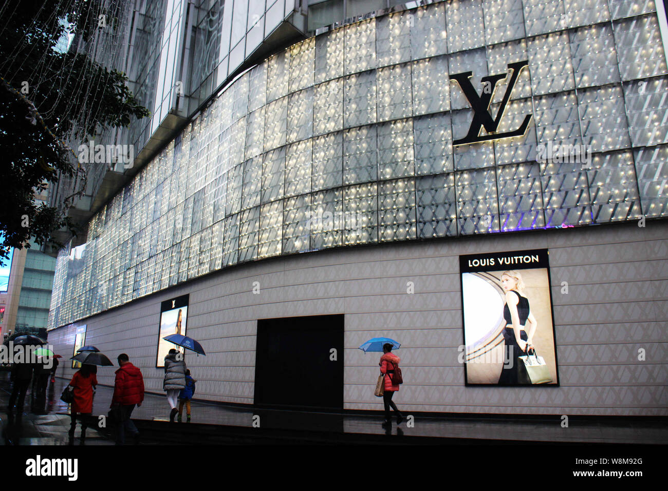 FILE--Pedestrians walk past a Louis Vuitton (LV) store in