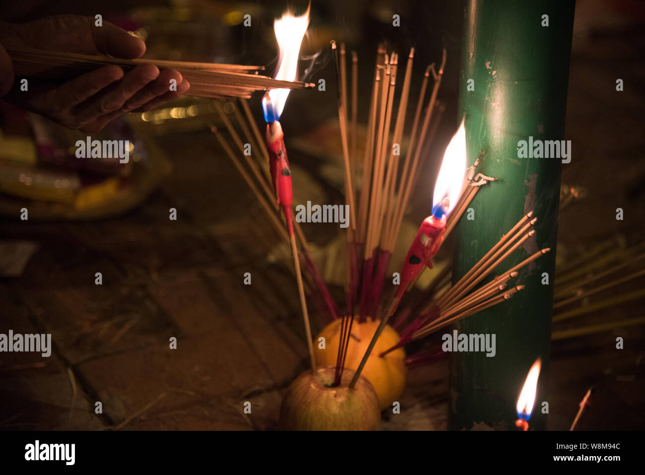 Protesters light incense in celebration of the Ghost Festival.Protesters took to the streets of Hong Kong again, this time using the Hungry Ghost Festival as a way to demonstrate against the government. Protesters burn various paper offerings as a way to appease ancestors and spirits. Stock Photo