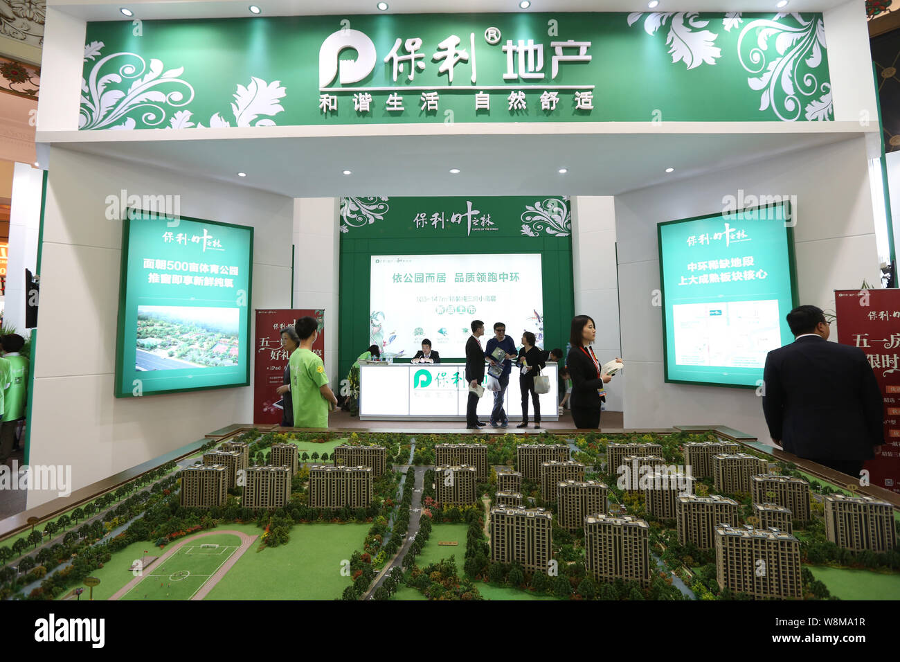 --FILE--Chinese homebuyers visit the stand of Poly Real Estate Group during a real estate fair in Shanghai, China, 30 April 2014.   Poly Real Estate G Stock Photo