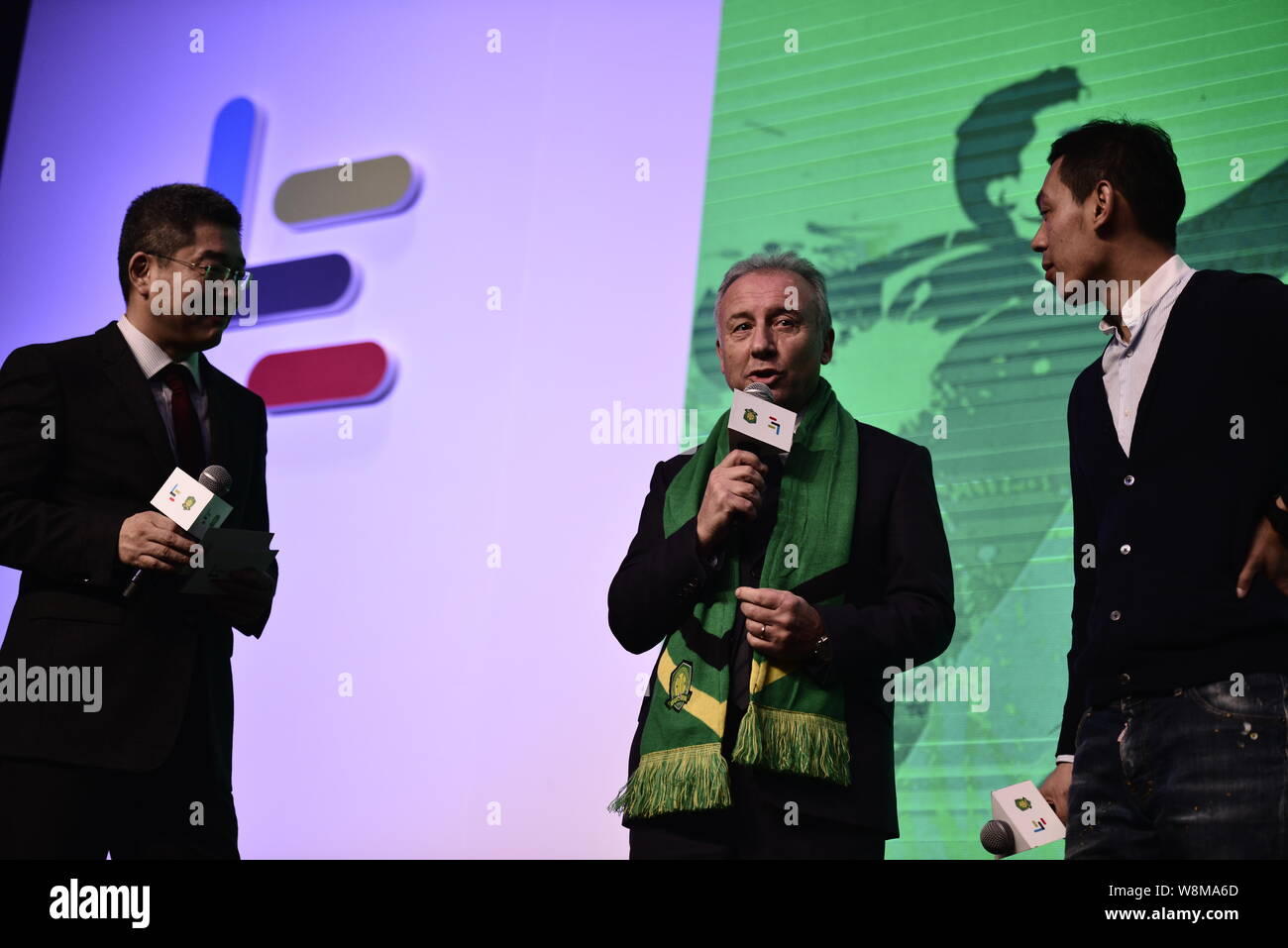 Head coach Alberto Zaccheroni, center, of Beijing Guoan F.C. attends a press conference to announce the strategic partnership between LeTV and Beijing Stock Photo
