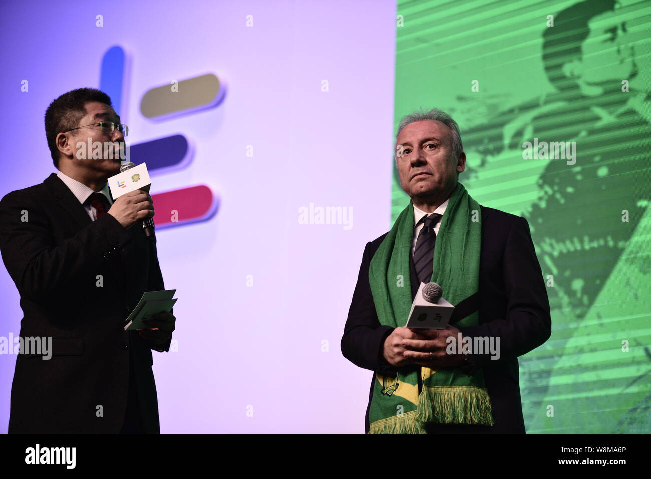 Head coach Alberto Zaccheroni, right, of Beijing Guoan F.C. attends a press conference to announce the strategic partnership between LeTV and Beijing Stock Photo