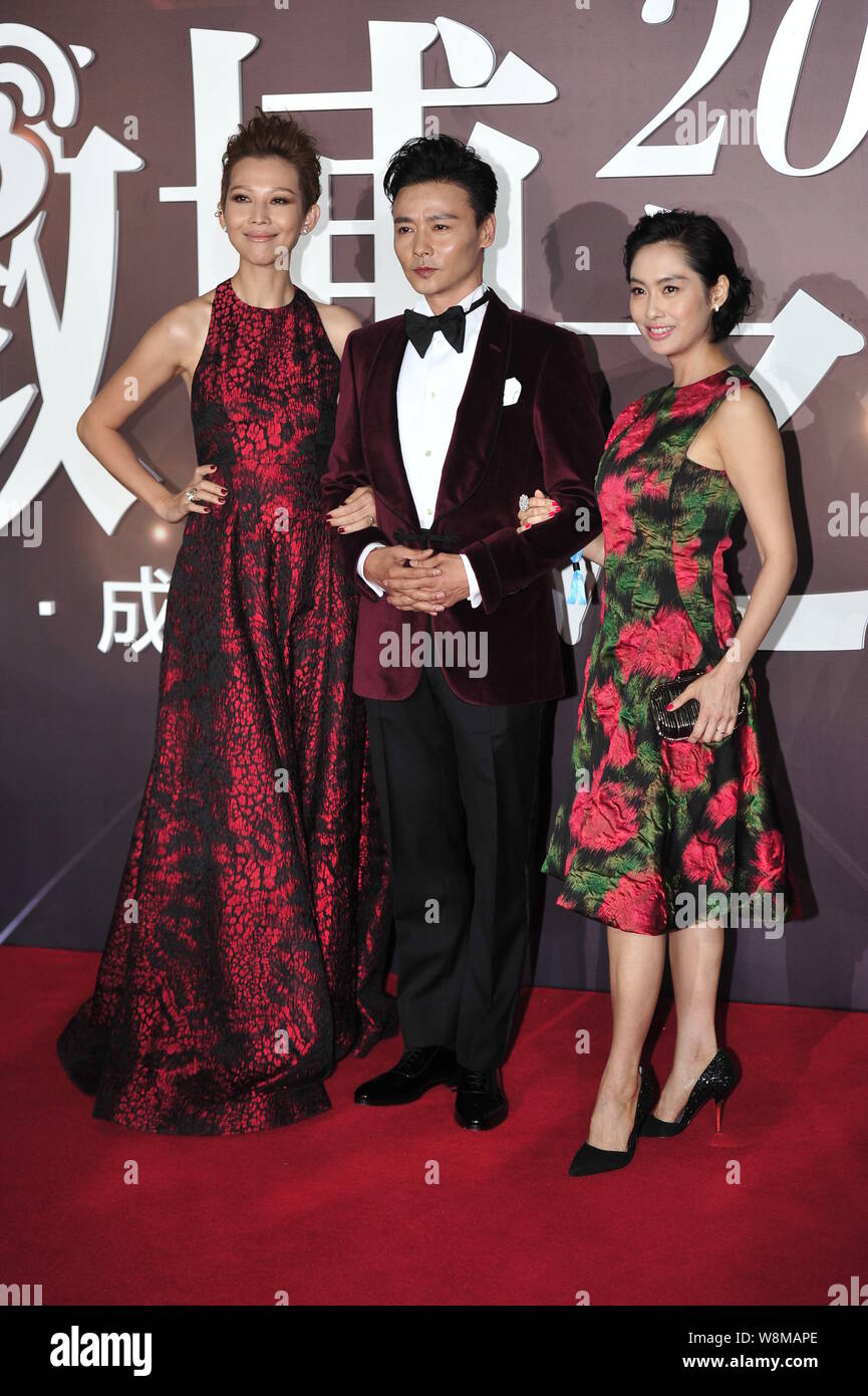 (From left) Hong Kong actress Ada Choi, her Chinese actor husband Zhang Jin and Hong Kong actress Athena Chu arrive on the red carpet for the 2015 Wei Stock Photo