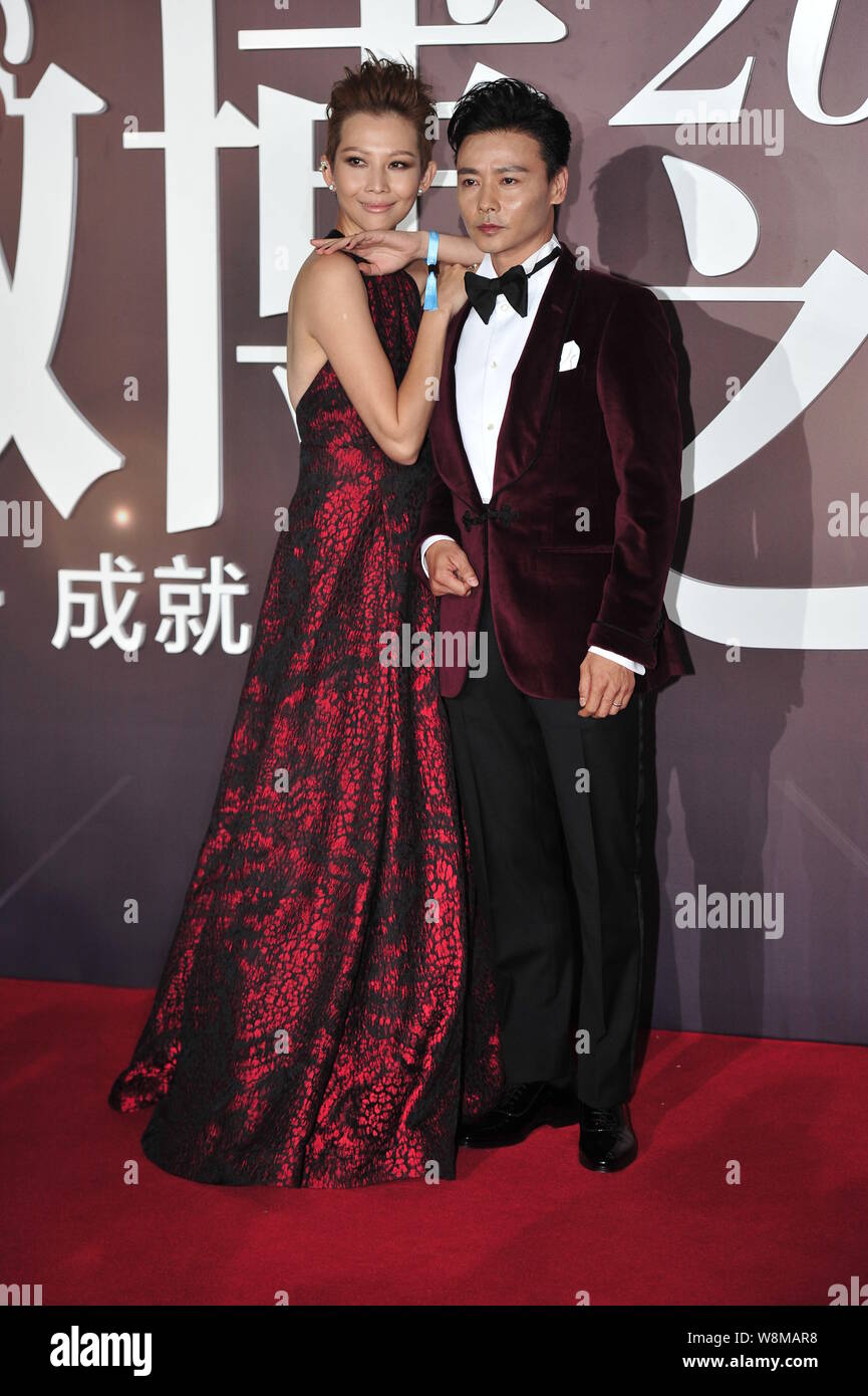 Hong Kong actress Ada Choi, left, and her Chinese actor husband Zhang Jin arrive on the red carpet for the 2015 Weibo Awards Ceremony in Beijing, Chin Stock Photo