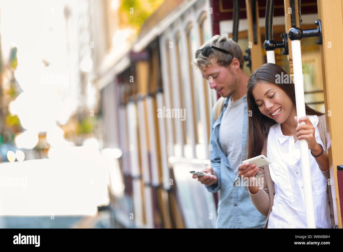 San Francisco cable car tourists people texting using mobile phone