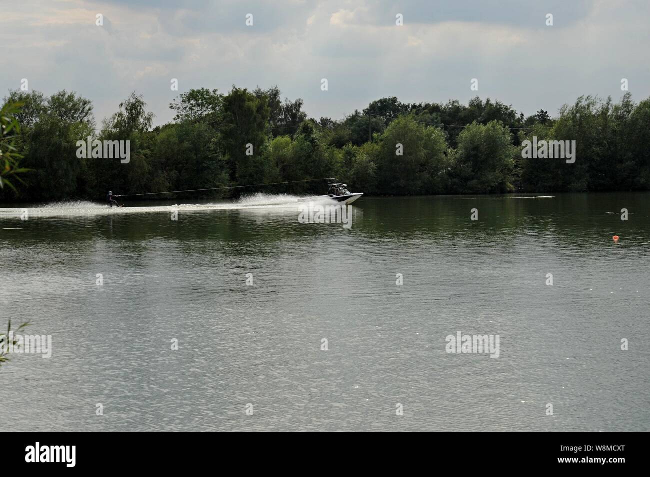 A person water wakeboarding on the Netherton Resevoir, adjacent to the Dudley Canal, Black Country, UK Stock Photo