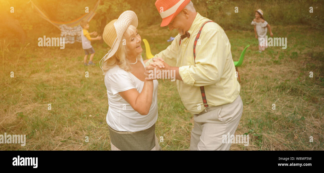 The Old Lady And Gentleman Dancing In The Garden2 Stock Photo