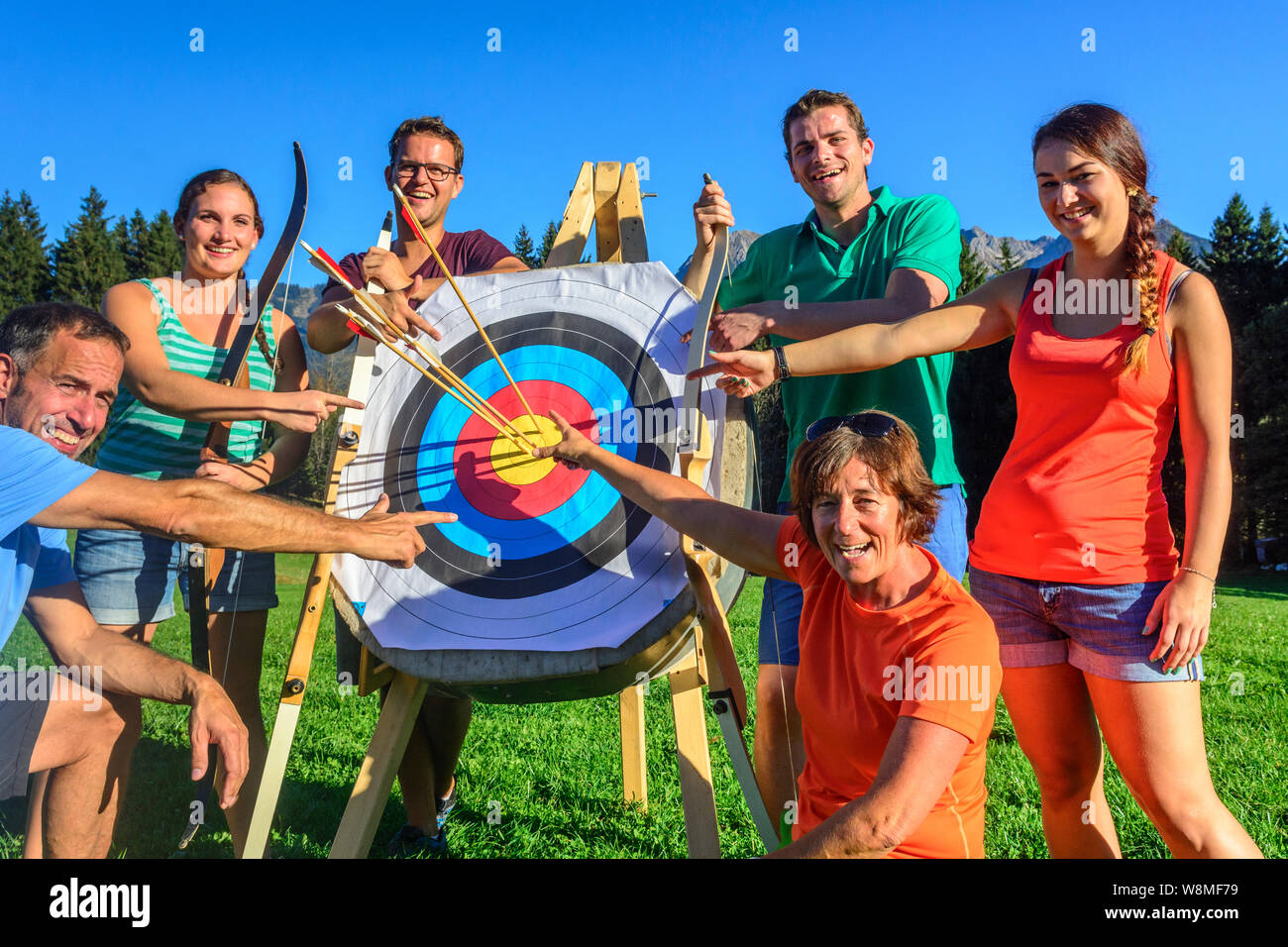 Group of happy people doing archery Stock Photo Alamy
