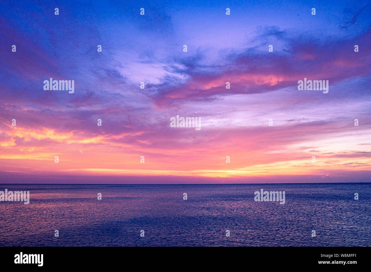 Colorful sunset sky over the ocean with dramatic cloud formation Stock Photo
