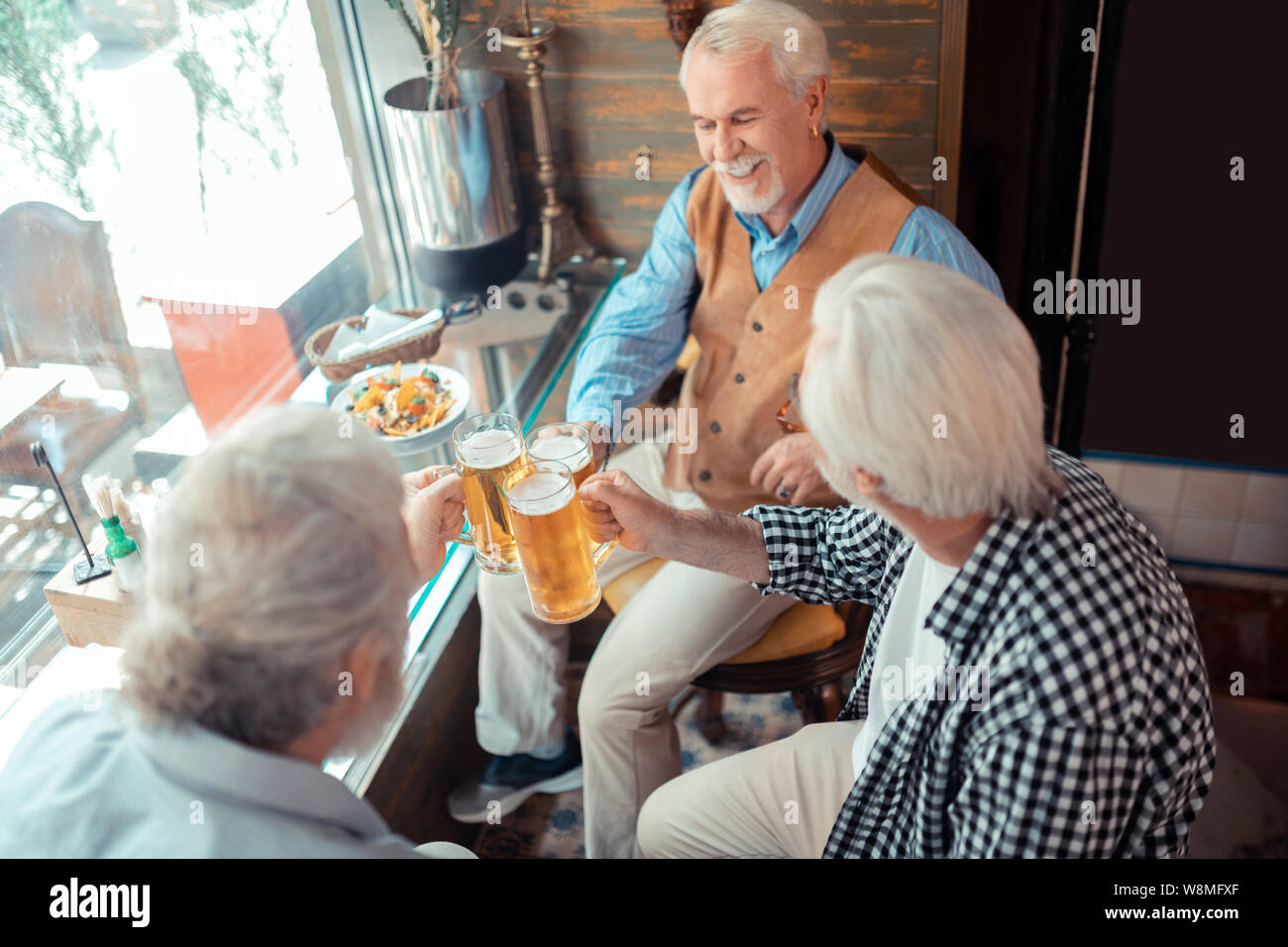Top view of pensioners eating and drinking beer in pub Stock Photo Alamy
