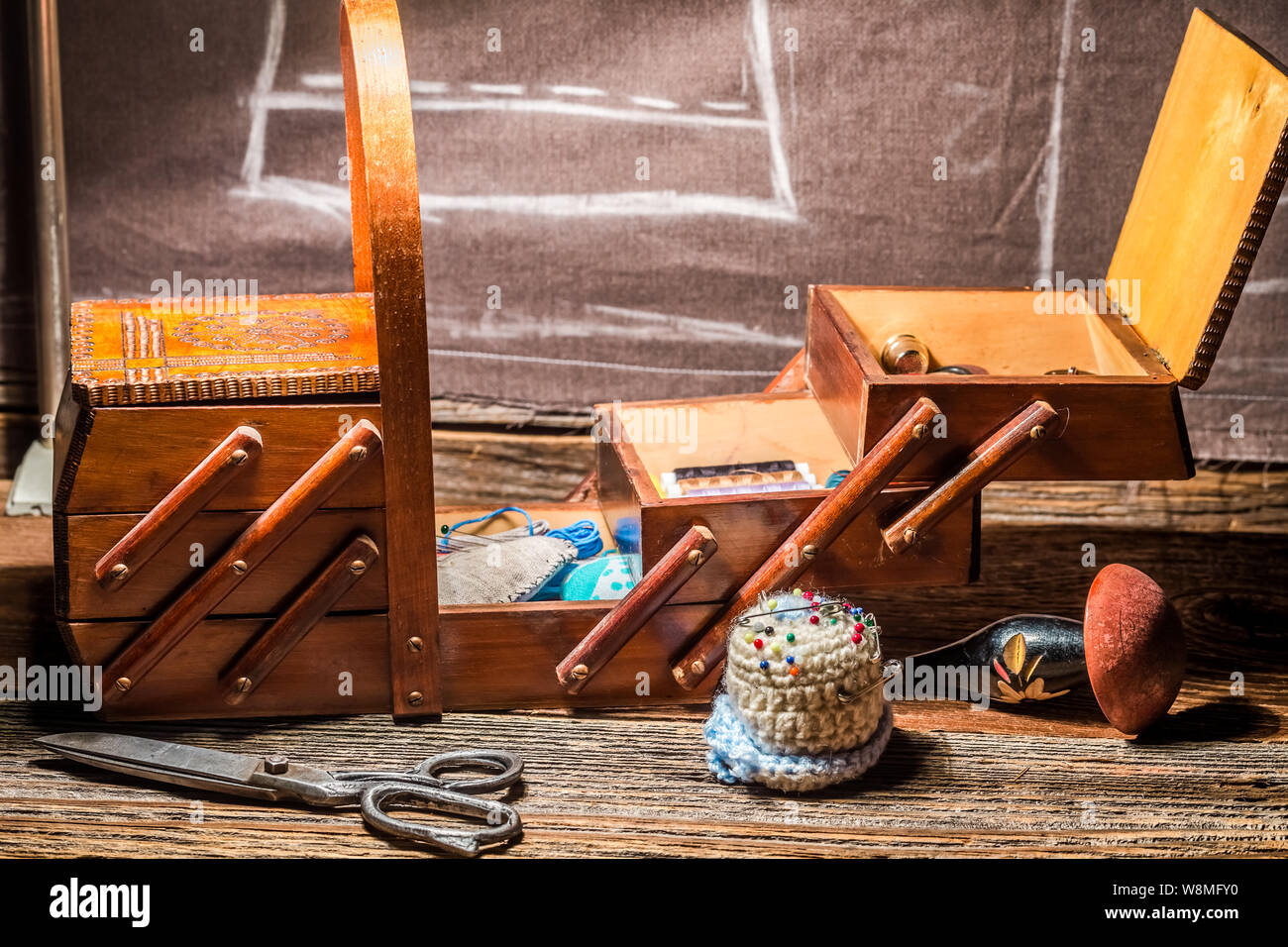 Threads, needles and materials in sewing workshop Stock Photo
