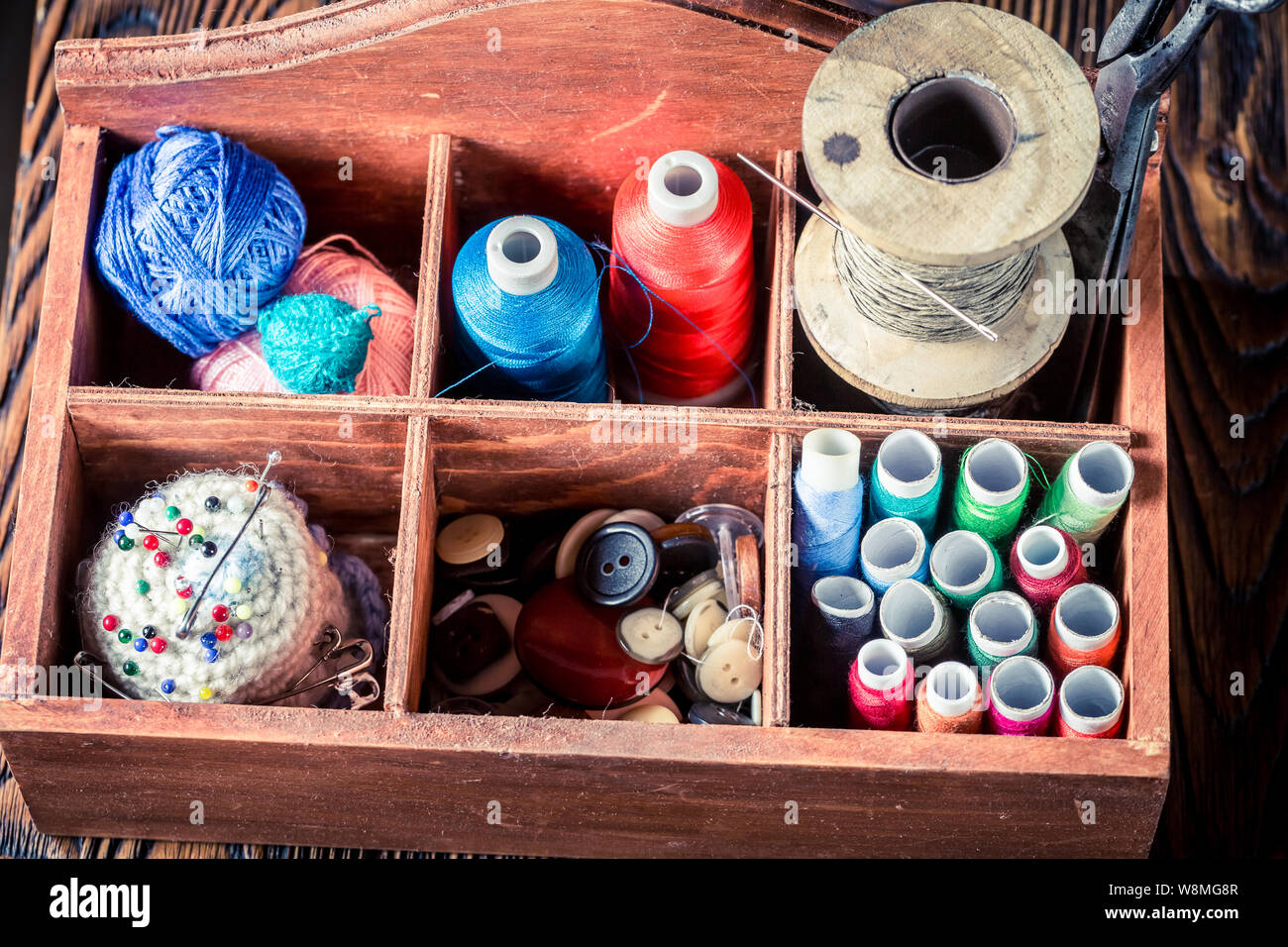 Threads, needles and buttons in tailor wooden box Stock Photo Alamy