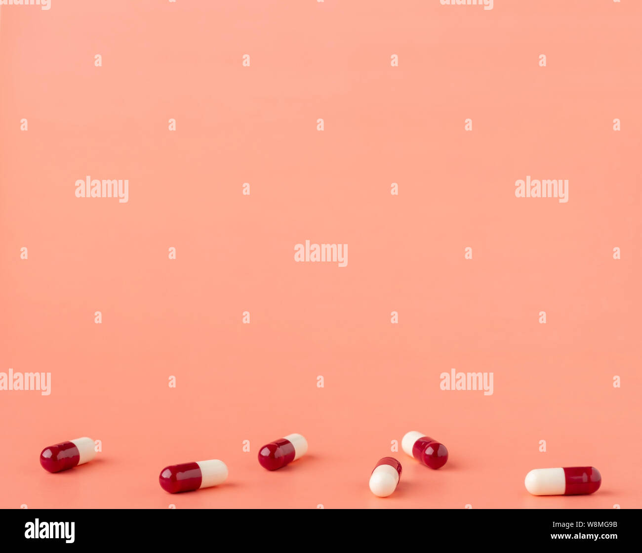 Scattering of red and white drug capsules Stock Photo