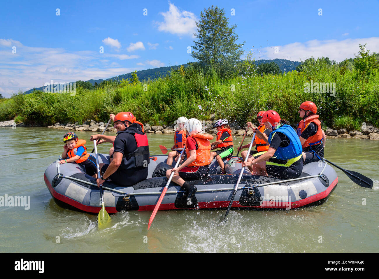 River rafting with families and children on the river Iller in the Allgäu alps Stock Photo