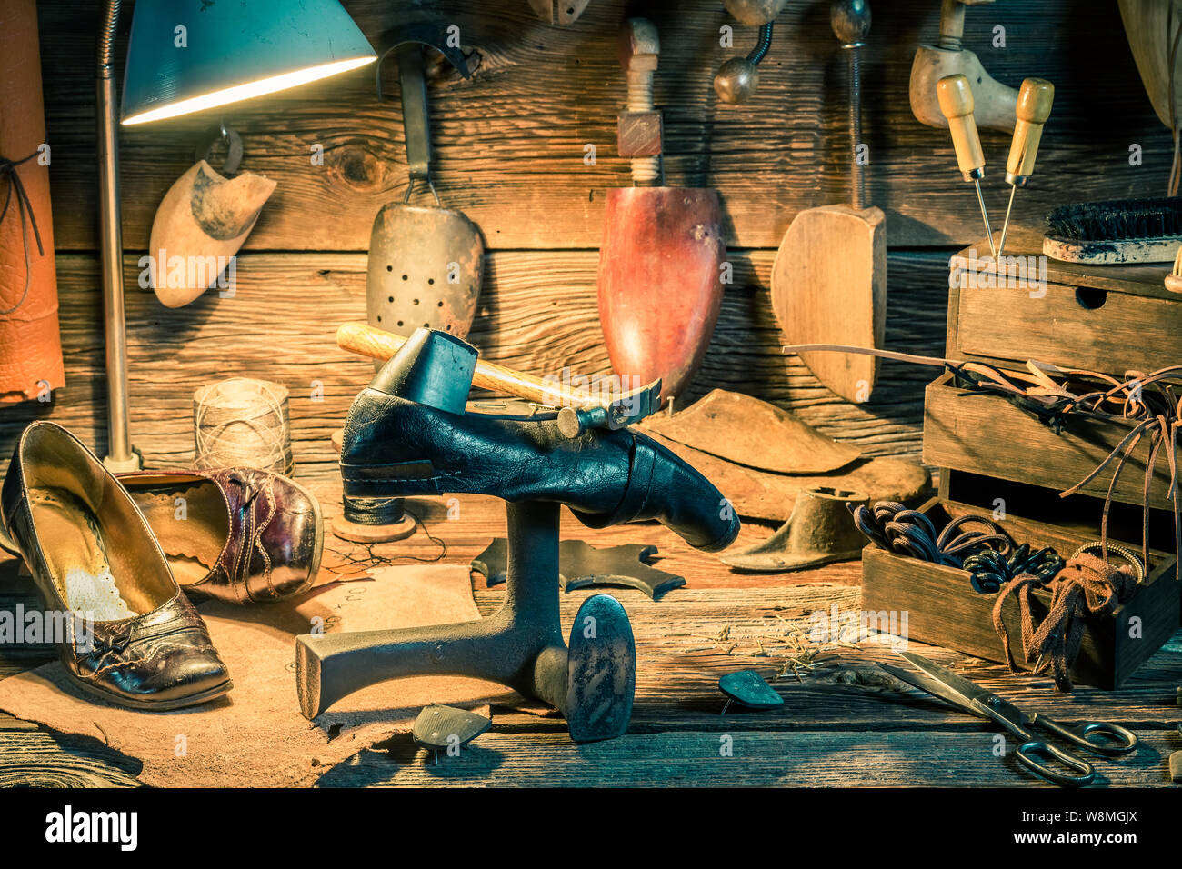 Rustic shoemaker workplace with shoes, tools and laces Stock Photo - Alamy